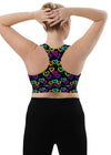 Back view of woman in Neon Hearts Print Black High Impact Sports Bra, large size. Featuring a supportive racerback design and high-impact support, ideal for intense gym sessions and running.