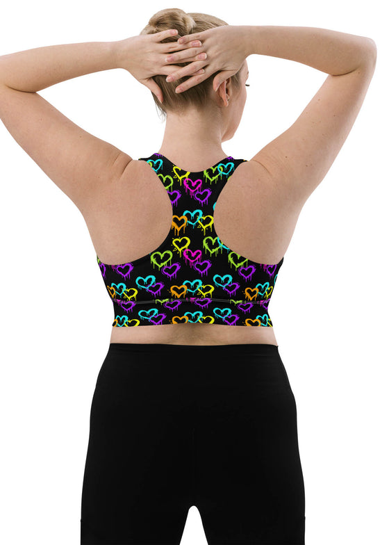 Back view of woman in Neon Hearts Print Black High Impact Sports Bra, large size. Featuring a supportive racerback design and high-impact support, ideal for intense gym sessions and running.