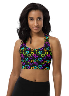  Woman wearing Neon Hearts Print Black High Impact Sports Bra. Featuring a vibrant neon heart pattern, this racerback sports bra offers maximum support and comfort for intense gym workouts and running.