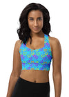 Woman wearing Neon Hearts Print Blue High Impact Sports Bra with vibrant neon hearts on a blue background. Designed for intense workouts, yoga, and casual outings, offering high support and comfort.