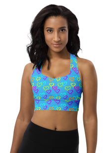  Woman wearing Neon Hearts Print Blue High Impact Sports Bra with vibrant neon hearts on a blue background. Designed for intense workouts, yoga, and casual outings, offering high support and comfort.