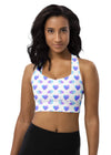 Woman wearing Neon Hearts White Racerback Longline Sports Bra with vibrant neon heart print. Offers high support for gym workouts and everyday wear, featuring a flattering longline fit and freedom of movement with racerback design.
