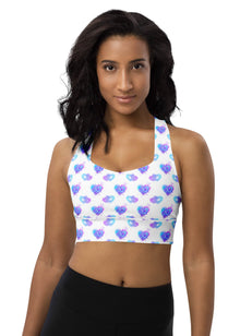  Woman wearing Neon Hearts White Racerback Longline Sports Bra with vibrant neon heart print. Offers high support for gym workouts and everyday wear, featuring a flattering longline fit and freedom of movement with racerback design.
