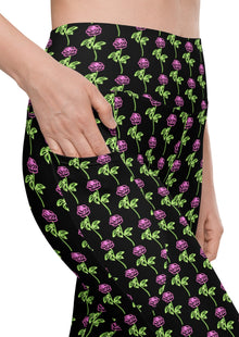  Close-up of neon roses black high-waisted leggings with pockets, showcasing the vibrant floral design and convenient side pockets for women’s essentials. Perfect for workouts or casual wear.