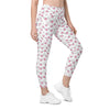 Front view of model wearing white high waisted leggings with heart print. Compression leggings for women with pockets, perfect for gym or yoga sessions.
