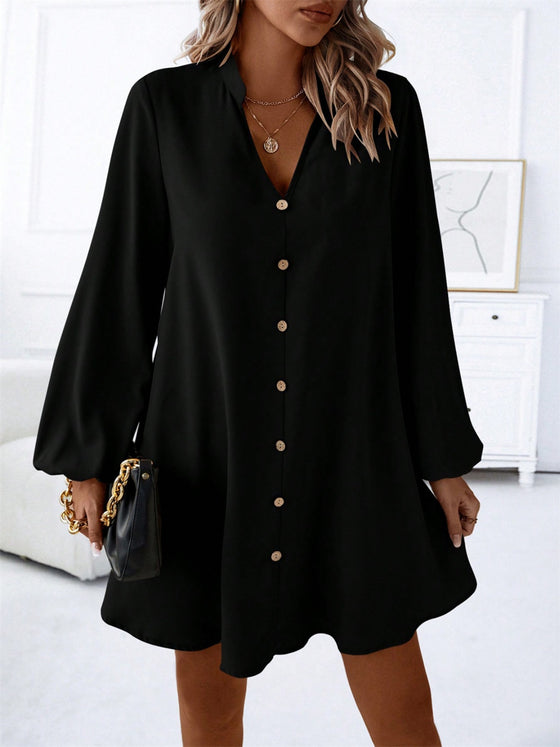 Woman wearing a Notched Long Sleeve Mini Dress in black, featuring a button-down design, long sleeves, and a notched neckline for a chic and versatile look.

