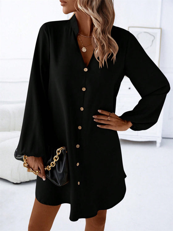 Model wearing the Notched Long Sleeve Mini Dress, styled with a black handbag and gold accessories for a polished look.