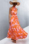 Orange maxi dress with a tropical-inspired print and tie waist—sleek and breezy, ideal for vacations, poolside lounging, or brunch dates.