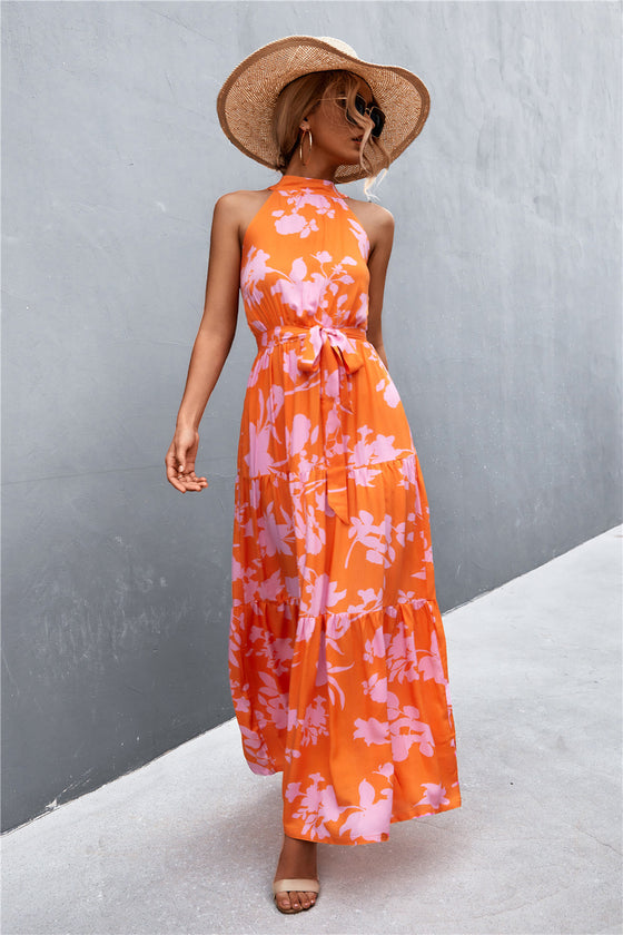 Full front view of vibrant orange printed sleeveless maxi dress—bold summer statement piece with waist tie for a flattering fit.