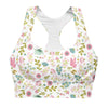Closeup of front showing pastel floral print and longline compression fit. Features removable padding and double-layered front for workout-ready support.