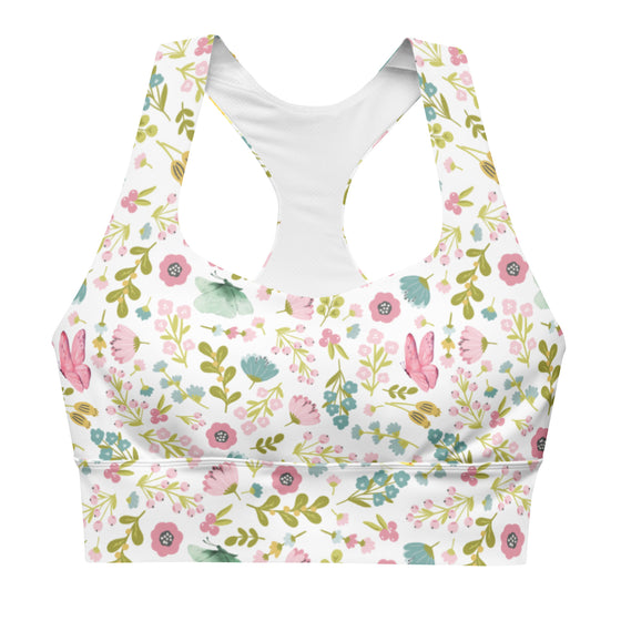 Closeup of front showing pastel floral print and longline compression fit. Features removable padding and double-layered front for workout-ready support.