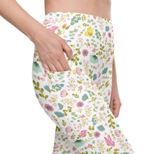  Closeup of white high waisted leggings with pastel spring floral print and deep side pocket. Compression leggings with pockets for women.