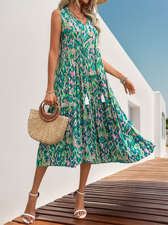 Woman wearing the Perfee Tassel Printed Tie Neck Sleeveless Dress paired with a straw hat and accessories, perfect for summer adventures.