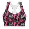 Closeup of front design showing compression fit and double-layered support. Bold pink and black cactus print sports bra with removable padding and mesh lining.