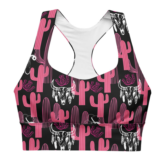 Closeup of front design showing compression fit and double-layered support. Bold pink and black cactus print sports bra with removable padding and mesh lining.