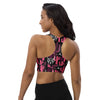 Back view of model wearing longline high support sports bra in pink and black cactus print. Racerback design allows full mobility and secure fit during workouts.