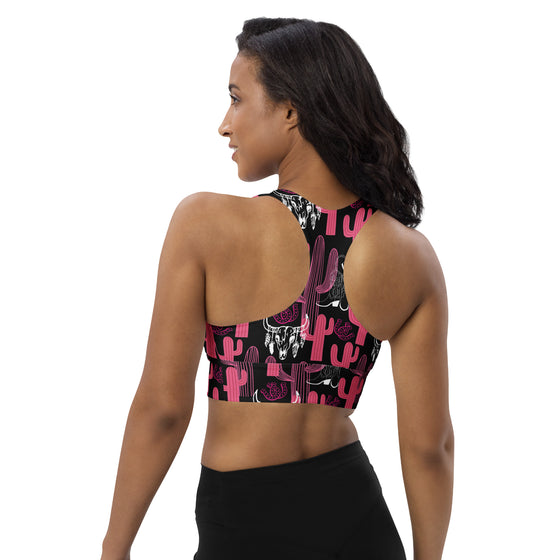 Back view of model wearing longline high support sports bra in pink and black cactus print. Racerback design allows full mobility and secure fit during workouts.