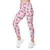 Woman walking in gym leggings with pockets featuring bold pink cactus print. High waist compression leggings ideal for yoga, workouts, or daily wear.