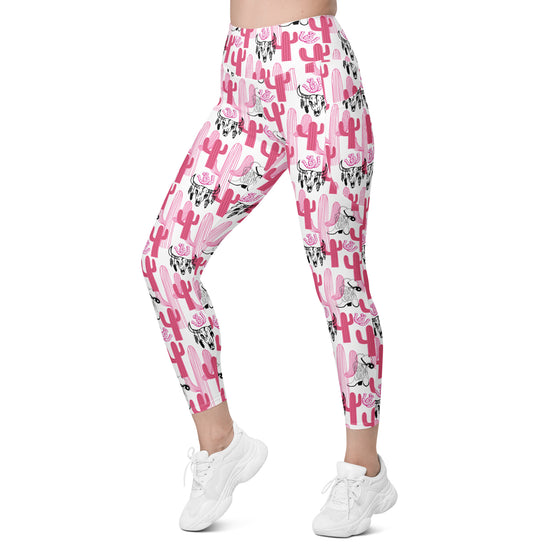 Woman walking in gym leggings with pockets featuring bold pink cactus print. High waist compression leggings ideal for yoga, workouts, or daily wear.