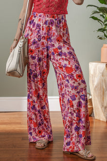  Woman modeling pink elastic high waist pants in a relaxed front pose, featuring a soft waistband and tapered leg cut for everyday comfort.