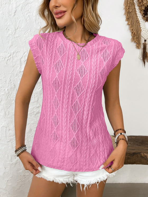 Model wears pink version of the top, emphasizing the round neck cut and elegant eyelet embroidery.


