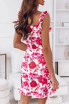  Back view of pink floral mini dress showcasing zip closure and soft fit—chic, romantic option for summer or spring outings.