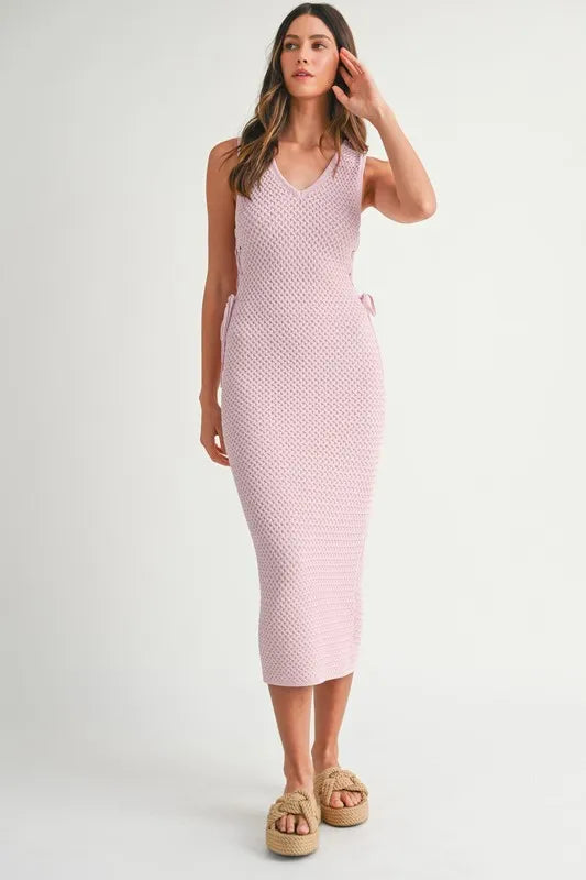 Sleek feminine look of the Pink Lavender Lace Up Knit Midi Dress captured from the front with lace-up accents.