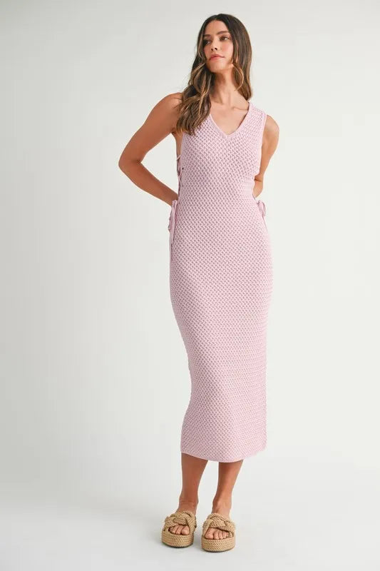 Soft knit detail of the Pink Lavender Lace Up Knit Midi Dress shown from the front with elegant lace-up design.