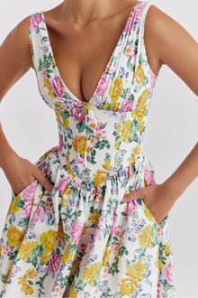  Model wearing a pink multicolor floral sleeveless midi dress with a soft flared hem and vibrant flower print for a charming, everyday summer look.