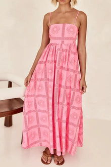   Pink square neck maxi dress adorned with delicate floral print, styled with flowing fabric and a flattering front silhouette for feminine appeal.