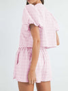 Back view of the pink set, highlighting the comfortable and relaxed fit with a flattering V-neck top and tailored shorts, perfect for casual, warm-weather wear.

