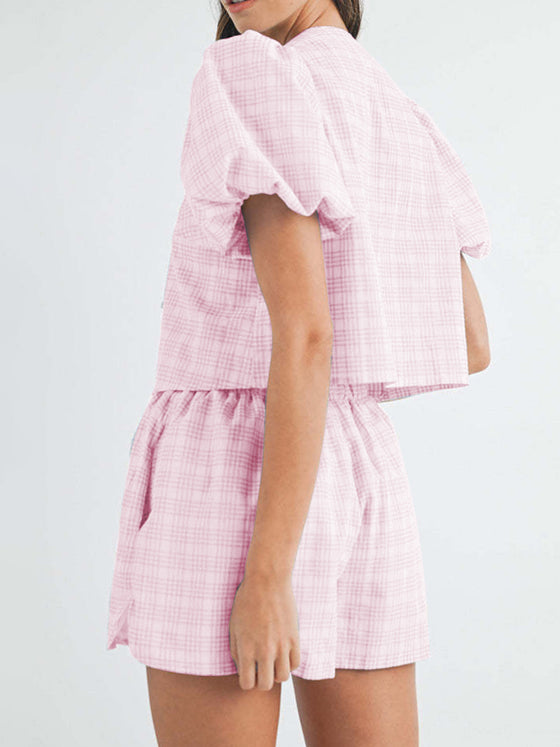 Back view of the pink set, highlighting the comfortable and relaxed fit with a flattering V-neck top and tailored shorts, perfect for casual, warm-weather wear.

