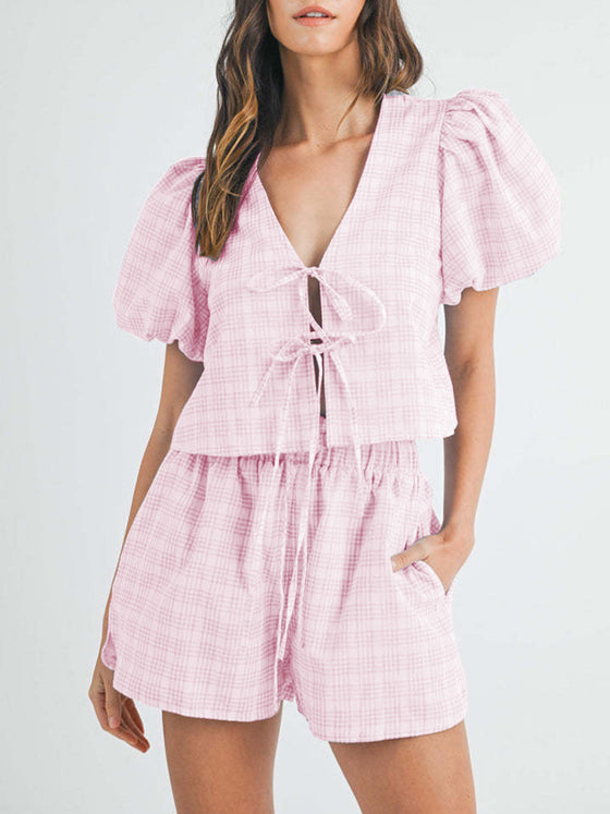 Front view of the pink V-neck puff sleeve top and shorts set, showcasing the bold and feminine color paired with puff sleeves and a flattering V-neckline for a stylish, trendy look.

