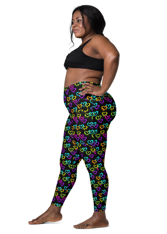 Side view of a plus-size woman wearing Black Rainbow Melting Hearts High-Waisted Yoga Leggings with pockets, offering compression, stretch, and a comfortable fit.