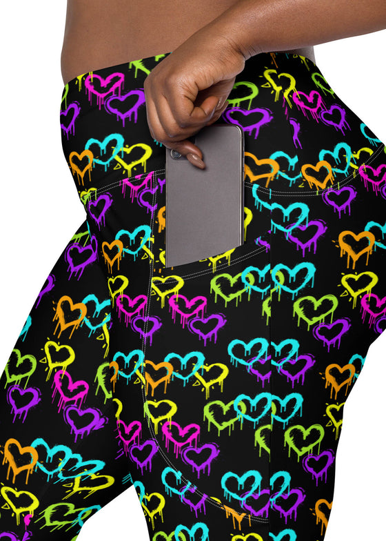 Close-up of the pocket design on plus-size Black Rainbow Melting Hearts High-Waisted Compression Leggings, ideal for carrying essentials during workouts and yoga.