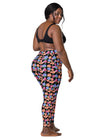 Plus-size woman in Black Floral High Waisted Leggings with Pockets, demonstrating the back view with comfortable compression fit and fashionable floral print.