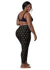 Plus-size woman wearing Zen Frog black high-waisted leggings with pockets, featuring a fun frog print and offering a secure fit for yoga and exercise.