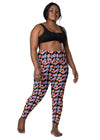 Plus-size woman in Black Floral High Waisted Leggings with Pockets, showcasing the flattering floral design and high waist fit for a confident, stylish workout.