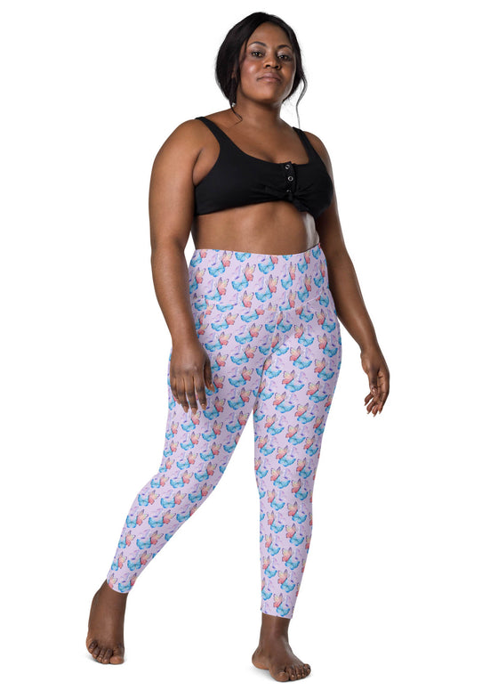 Plus-size woman wearing lavender butterfly print high-waisted leggings with pockets, offering a comfortable and flattering fit for all body types.