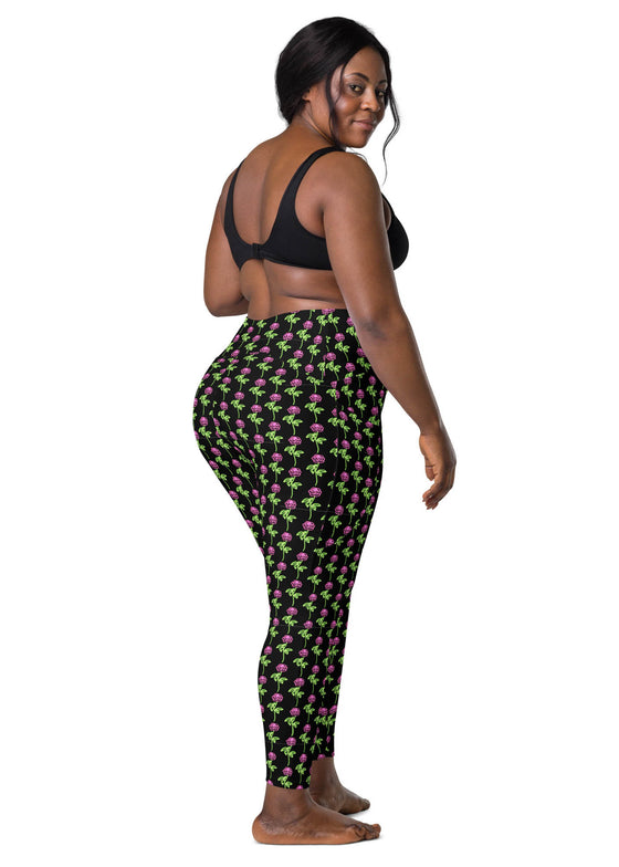 Plus-size woman wearing neon roses black high-waisted leggings, back view. Designed with a flattering fit and practical side pockets, perfect for yoga or daily use.