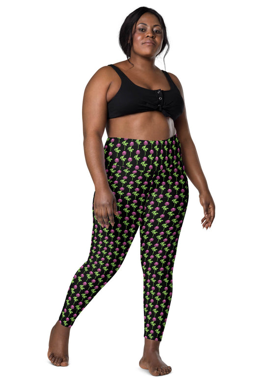 Plus-size woman wearing neon roses black high-waisted leggings, front view. High-waisted design for comfort and side pockets for practical use, ideal for casual and active wear.