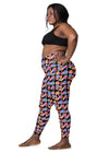 Plus-size woman in Black Floral High Waisted Leggings with Pockets, demonstrating the side view with comfortable compression fit and fashionable floral print.