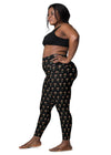 Plus-size woman wearing Zen Frog black high-waisted leggings with pockets, featuring a fun frog print and offering a secure fit for yoga and exercise.