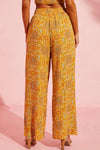 Back view of the Pocketed Floral Wide Leg Pants, displaying the relaxed fit and colorful print.