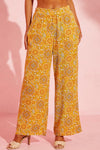 Woman wearing vibrant floral wide-leg pants with pockets, perfect for casual and stylish occasions.