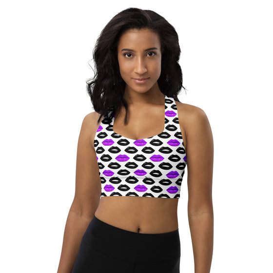 Model wearing Pop Lips white high impact longline sports bra with purple and black lips print. Racerback cut and compression fit perfect for gym workouts.