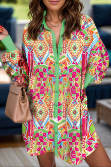  Woman wearing a vibrant printed button-up long sleeve shirt dress styled with a beige bag, perfect for work or casual outings.

