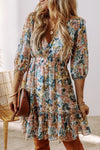 Front view of the Printed V-Neck Half Sleeve Dress showcasing its floral print and ruffled hem.