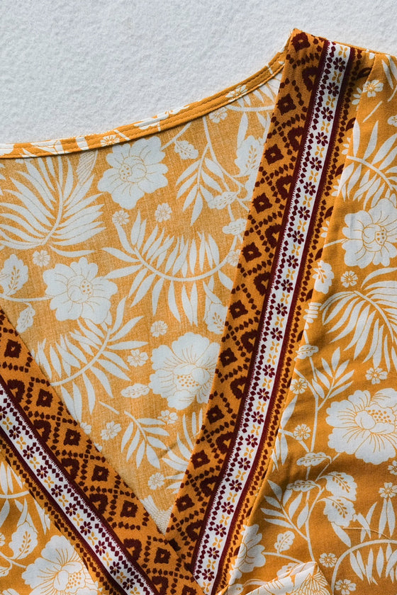 Close-up of the half-sleeve tie-front top, featuring detailed floral prints and a flattering V-neckline.