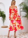 Back view of the Printed Long Sleeve Midi Dress showcasing its vibrant prints, tied waist, and off-shoulder neckline.